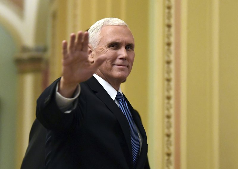 In this Jan. 3, 2018, file photo, Vice President Mike Pence waves as he walks on Capitol Hill in Washington. 