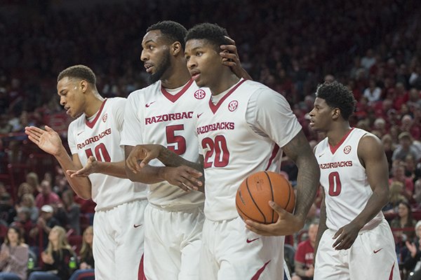 Arkansas players Arlando Cook (5), Darious Hall (20) and Daniel Gafford (10) react to a call during a game against Ole Miss on Saturday, Jan. 20, 2018, in Fayetteville. 