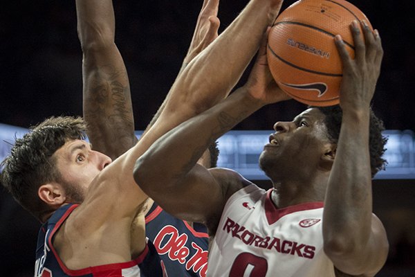 Arkansas guard Jaylen Barford drives against Ole Miss defenders during a game Saturday, Jan. 20, 2018, in Fayetteville. 