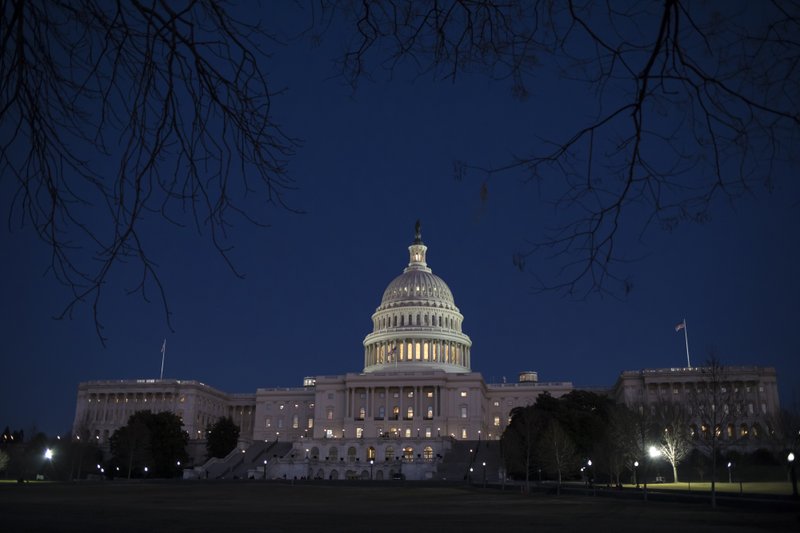 With no apparent indications of a breakthrough in the Senate to avoid a government shutdown, the Capitol is illuminated in Washington, Friday evening, Jan. 19, 2018. (AP Photo/J. Scott Applewhite)