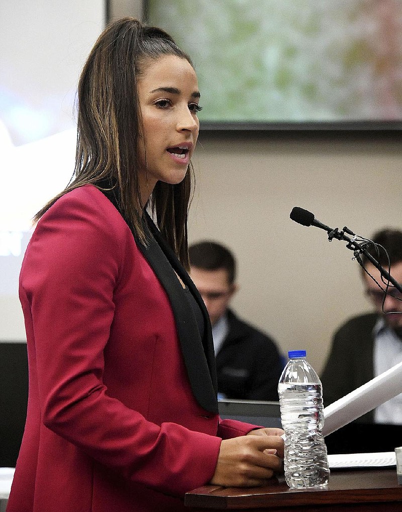 Olympic gold medalist Aly Raisman gives her victim impact statement, Friday, Jan. 19, 2018, in Lansing, Mich., during the fourth day of sentencing for former sports doctor Larry Nassar, who pled guilty to multiple counts of sexual assault.  (Dale G. Young/Detroit News via AP)