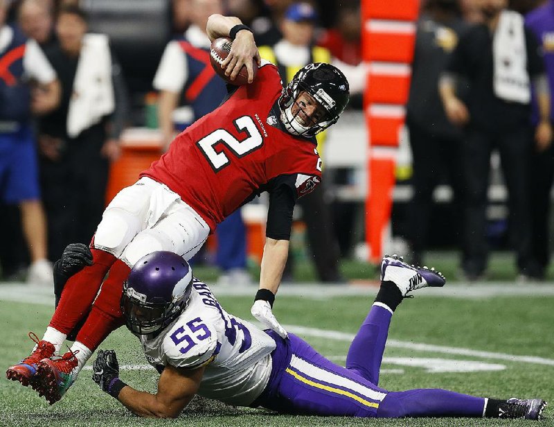 Minnesota Vikings linebacker Anthony Barr (55) tackles Atlanta Falcons quarterback Matt Ryan (2) during a Dec. 3 game in Atlanta. Four of the league’s top defenses go at it Sunday when the Eagles host the Vikings and the Patriots face the Jaguars.