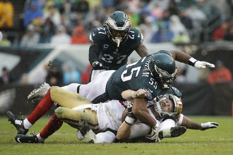 C.J. Beathard of the San Francisco 49ers is sacked by Brandon Graham (55) and Mychal Kendricks of the Philadelphia Eagles during the second half Oct. 29 in Philadelphia. The Eagles will match up their suffocating defense against the Vikings’ top-ranked defense in today’s NFC Championship Game.