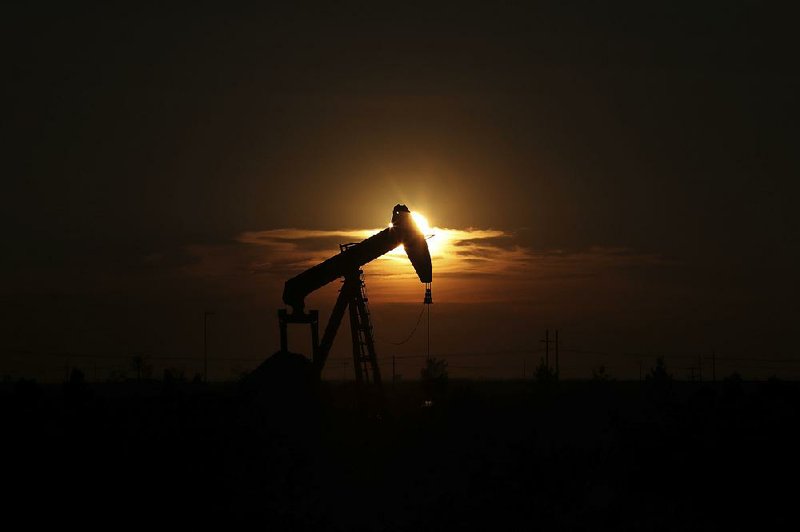 An oil rig is seen in June in Midland, Texas. American oil producers are restarting idled rigs as crude prices have risen about 50 percent since June.

