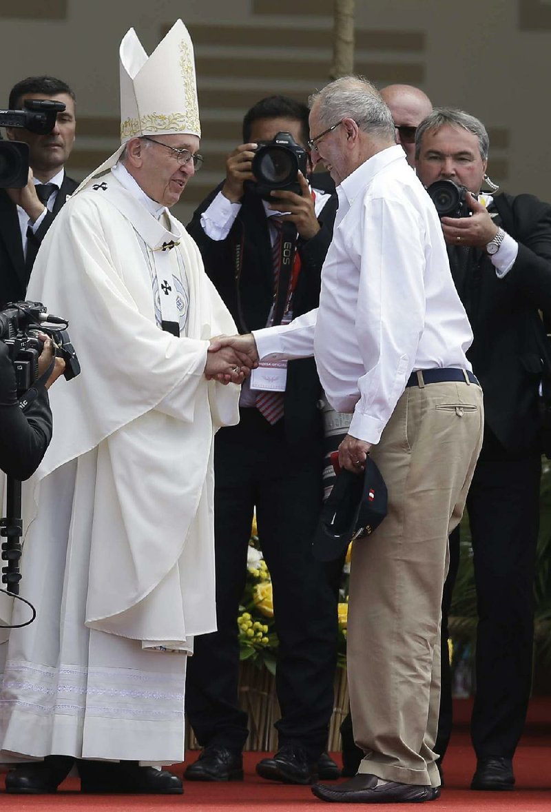 Pope Francis greets Peruvian President Pedro Pablo Kuczynski on Saturday after the pontiff celebrated a seaside Mass near Trujillo, Peru.