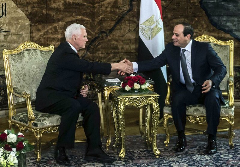 Vice President Mike Pence (left) shakes hands with Egyptian President Abdel-Fattah el-Sissi on Saturday at the presidential palace in Cairo.