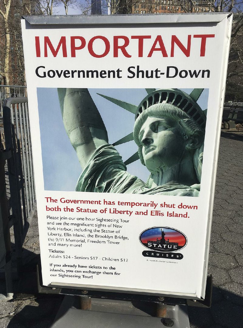 This sign was posted Saturday at the ferry to Ellis Island and the Statue of Liberty in New York after the government shutdown began at midnight Friday.