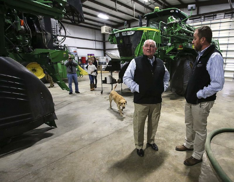 U.S. Secretary of Agriculture Sonny Perdue (center) gets a tour of Brantley Farms from owner Dow Brantley on Friday at the farm in England during Perdue’s second visit to Arkansas.