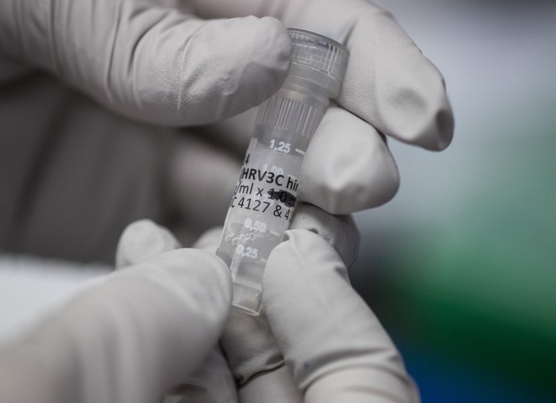 Biologist Rebecca Gillespie holds a vial of flu-fighting antibodies at the Vaccine Research Center at the National Institutes of Health, Tuesday, Dec. 19, 2017, in Bethesda, Md. Despite 100 years of science, the flu virus too often beats our best defenses because it constantly mutates. (AP Photo/Carolyn Kaster)