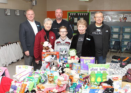 Terry Lawler, front left, Jacob Harbin, Judy Ellis, Dennis Berry, back left, Sean Lowery and Phil Ellis pose at CMS with some of the items Harbin is donating to The CALL. (The Senitnel-Record/Richard Rasmussen)