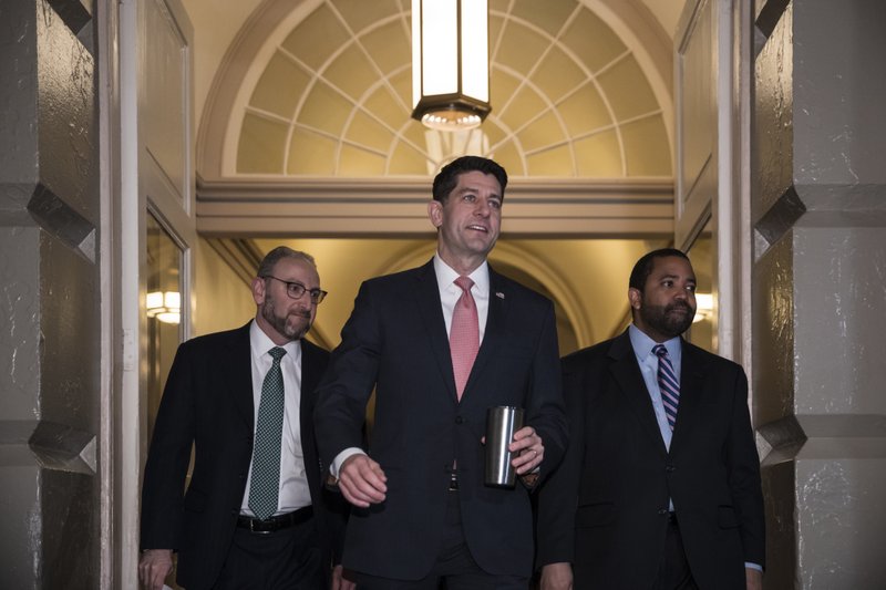 Speaker of the House Paul Ryan, R-Wis., arrives for a meeting of fellow Republicans on the first morning of a government shutdown after a divided Senate rejected a funding measure, at the Capitol in Washington, Saturday, Jan. 20, 2018. (AP Photo/J. Scott Applewhite)