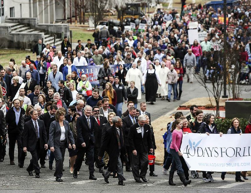People take part in the March for Life on the grounds of the state Capitol in Little Rock on Sunday.