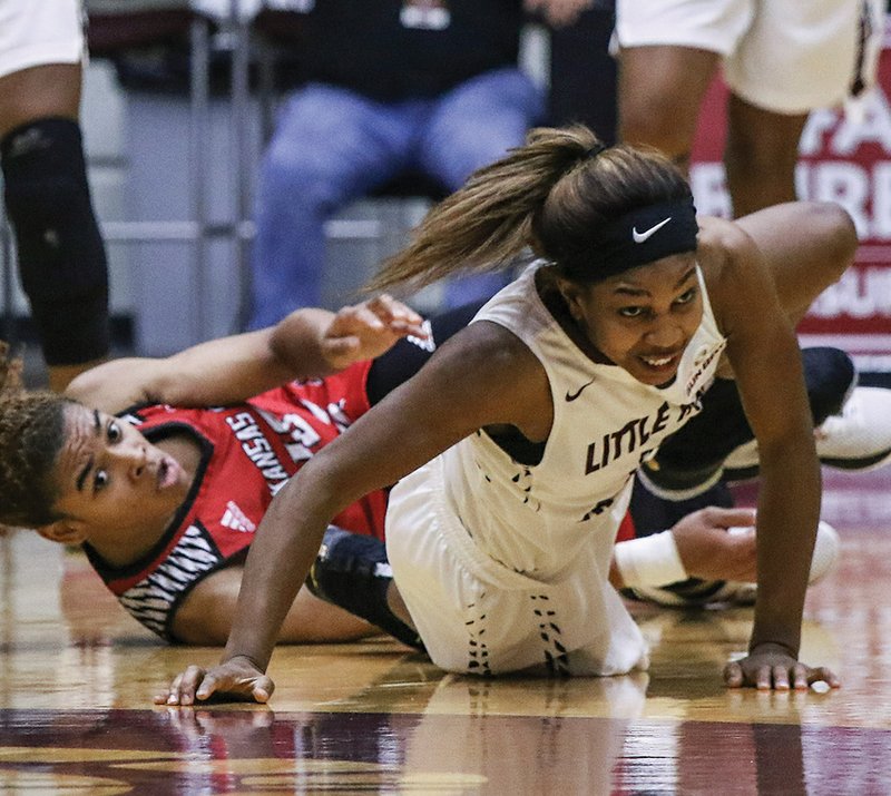 Arkansas Democrat-Gazette/Mitchell Pe Masilun SCRAPPY GAME: Arkansas State redshirt junior Akasha Westbrook, left, and Little Rock's Monique Townson fight for a loose ball Saturday during the Trojans' 53-43 home win at the Jack Stephens Center.