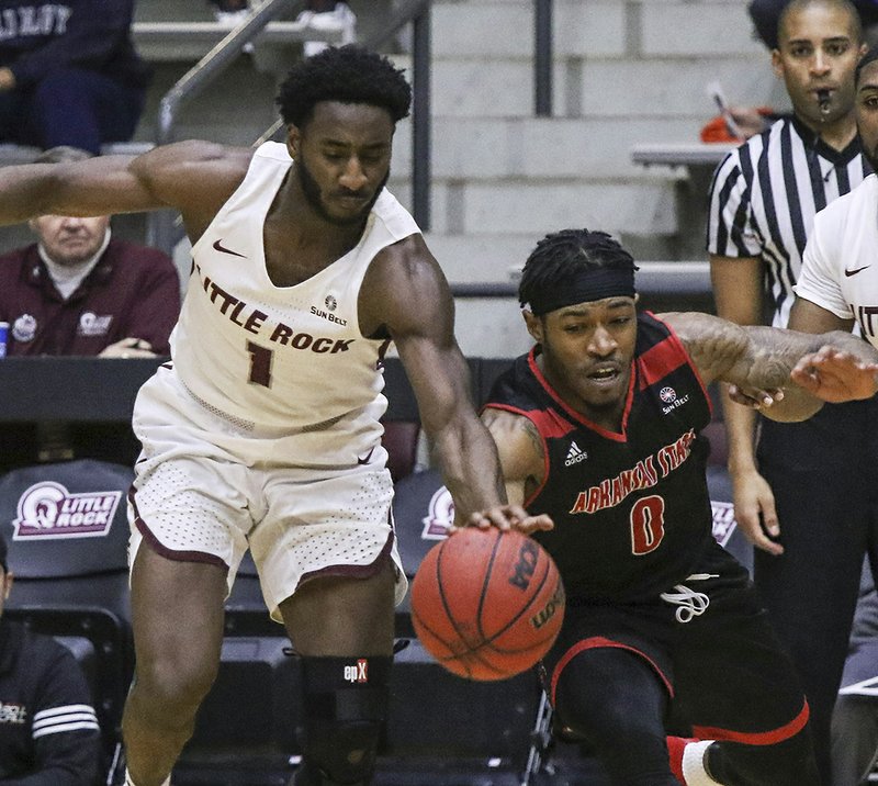 Arkansas Democrat-Gazette/Mitchell Pe Masilun IN-STATE BATTLE: Little Rock sophomore Andre Jones (1) and Arkansas State's Ty Cockfield (0) scramble for a loose ball during the Red Wolves' 70-62 win Saturday at the Jack Stephens Center.