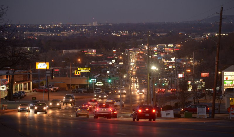 Traffic makes its way Thursday past Evelyn Hills Shopping Center along College Avenue in Fayetteville. Fayetteville plans to hire a consultant to assist with a redevelopment of the College Avenue corridor from North Street north to the city limit.