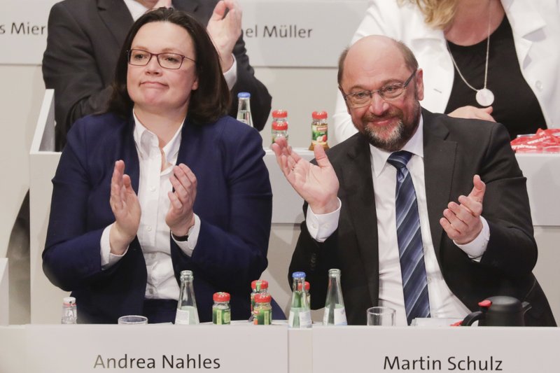 SPD's faction leader Andrea Nahles, left, and SPD's chairman Martin Schulz applaud after the delegates voted for coalition talks with Chancellor Angela Merkel's conservatives during a party meeting of the Social Democrats, SPD, in Bonn, Germany, Sunday, Jan. 21, 2018. 