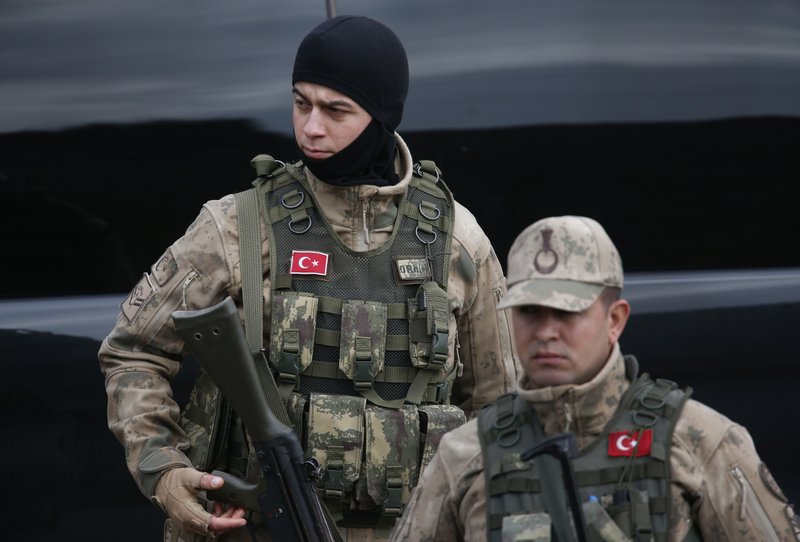 Turkish Army officers block the outskirts of the village of Sugedigi, Turkey, on the border with Syria, Sunday, Jan. 21, 2018. Turkey's ground troops entered the enclave of Afrin, in northern Syria on Sunday and were advancing with Turkish-backed Syrian opposition forces in their bid to oust Syrian Kurdish forces from the region.(AP Photo/Lefteris Pitarakis)