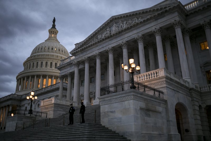 Night falls on the U.S. Capitol on second day of the federal shutdown as lawmakers negotiate behind closed doors in Washington, Sunday, Jan. 21, 2018. (AP Photo/J. Scott Applewhite)