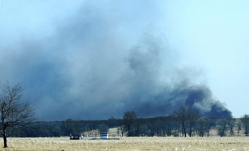 The McAlester News-Capital via AP/Kevin Harvison Smoke billows from the site of a gas well fire near Quinton, Okla., early Monday, Jan. 22, 2018. Several people are missing after a fiery explosion ripped through the eastern Oklahoma drilling rig, sending plumes of black smoke into the air and leaving a derrick crumpled onto the ground, an emergency official said.