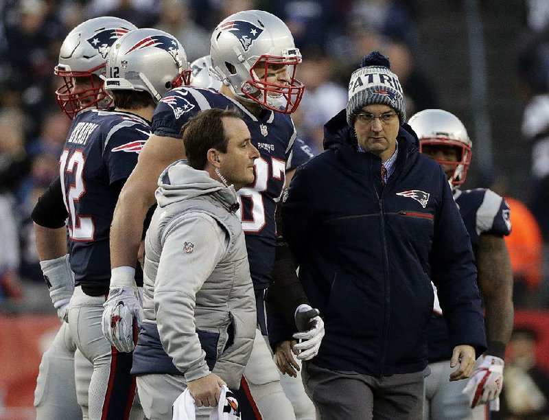 New England Patriots tight end Rob Gronkowski (center) is assisted off the field after a hit by Jacksonville Jaguars safety Barry Church during the fi rst half of the AFC Championship Game on Sunday in Foxborough, Mass.