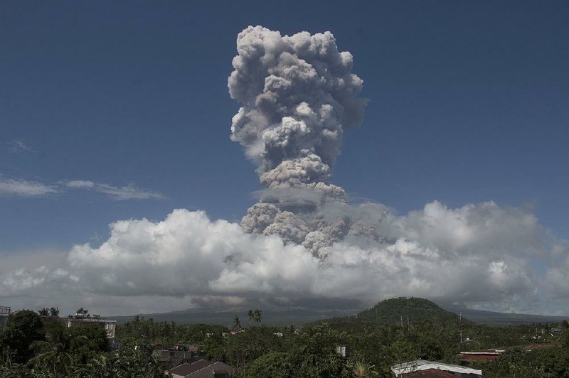 A column of ash shoots up during the eruption of the Mayon volcano Monday as seen from Legazpi city, Philippines.
