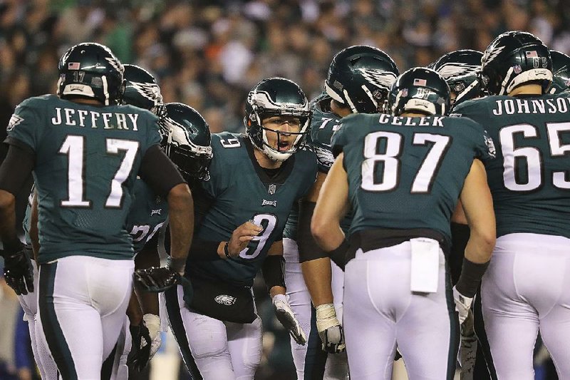 Philadelphia Eagles quarterback Nick Foles talks with his teammates in the huddle during the fourth quarter Sunday against the Minnesota Vikings in the NFC Championship Game in Philadelphia. Foles threw for 352 yards and 3 touchdowns to guide the Eagles to their fi rst Super Bowl appearance since 2004.