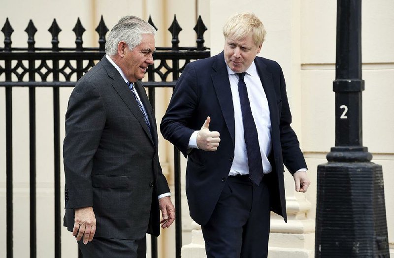 U.S. Secretary of State Rex Tillerson (left) is welcomed by Britain’s  Foreign Secretary Boris Johnson in London on Monday.