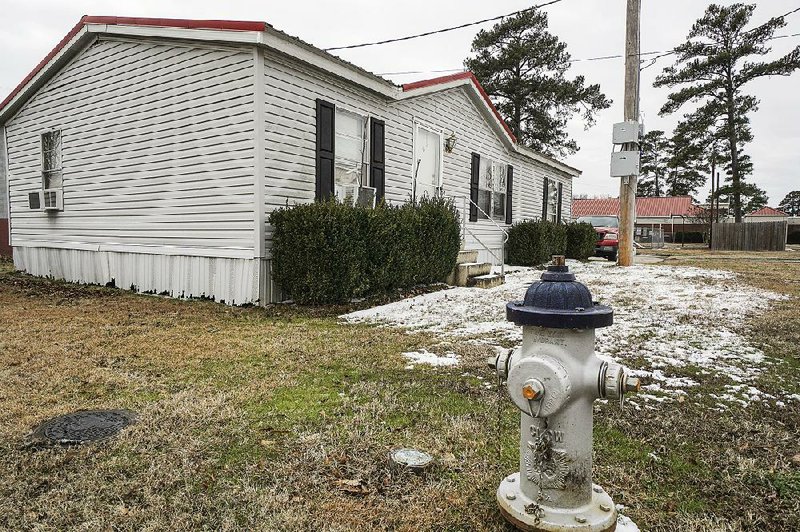 Snow melts Friday in the front of one of Bryant’s fi re stations, at 200 S.W. Third St.