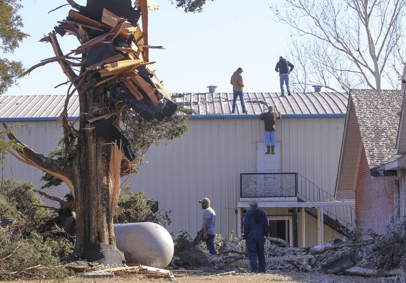 Springhill residents clean up Monday morning after a storm damaged several homes and structures in the small community near Greenbrier.