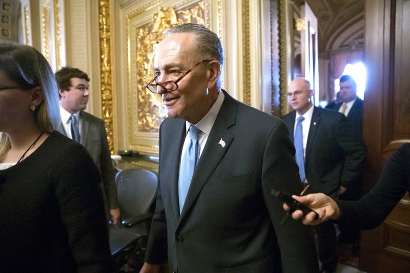 AP Photo/J. Scott Applewhite Senate Minority Leader Chuck Schumer, D-N.Y., heads to the chamber with fellow Democrats for a procedural vote aimed at reopening the government, at the Capitol in Washington, Monday, Jan. 22, 2018.