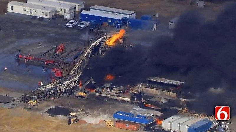 KOTV/NewsOn6.com via AP/Christina Goodvoice In this photo provided from a frame grab from Tulsa's KOTV/NewsOn6.com, fires burn at an eastern Oklahoma drilling rig near Quinton, Okla., Monday Jan. 22, 2018. Five people are missing after a fiery explosion ripped through a drilling rig, sending plumes of black smoke into the air and leaving a derrick crumpled on the ground, emergency officials said.