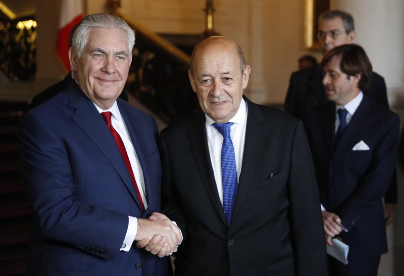 U.S. Secretary of State Rex Tillerson, left, shakes hands with French Foreign Affairs Minister Jean-Yves Le Drian before a meeting in Paris, Tuesday Jan. 23, 2018. Tillerson holds talks on the war in Syria and other regional issues with Le Drian. (Christian Hartmann, Pool via AP)
