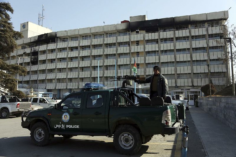 An Afghan police officer guards the front of Kabul’s Intercontinental Hotel on Tuesday. 