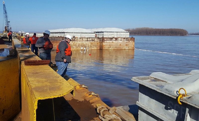 Arkansas Democrat-Gazette - 01/24/2018 - Officials look where the towboat "Virginia Renee"  sank with 10,000 gallons of diesel fuel at Hickman Landing on the Mississippi River near Blytheville, January 24, 2018. Booms and absorbent pads were being used to limit the spread of oil in the area, according to the Coast Guard.