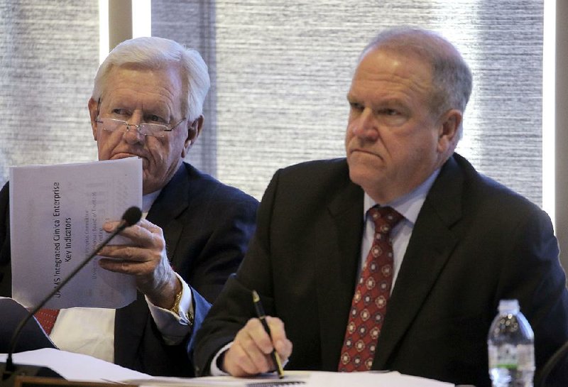 University of Arkansas System board of trustees Chairman Ben Hyneman (left) and Vice Chairman Mark Waldrip attend a meeting Wednesday at the University of Arkansas for Medical Sciences in Little Rock. 