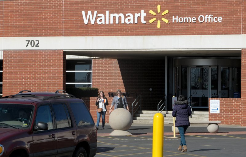 People walk Thursday outside Walmart Home Office in Bentonville. Wal-Mart Stores Inc. conducted a larger round of job cuts at its corporate offices in Bentonville on Thursday, eliminating positions across several departments.
