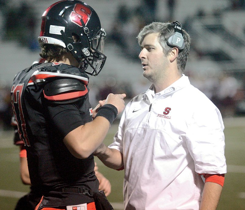 Searcy head football coach Mark Kelley, right, talks with quarterback Mason Schucker during the Lions’ first-round playoff win over Lake Hamilton in November. Kelley, who coached the Lions to a 10-3 record, is the 2017 Three Rivers Edition Coach of the Year.