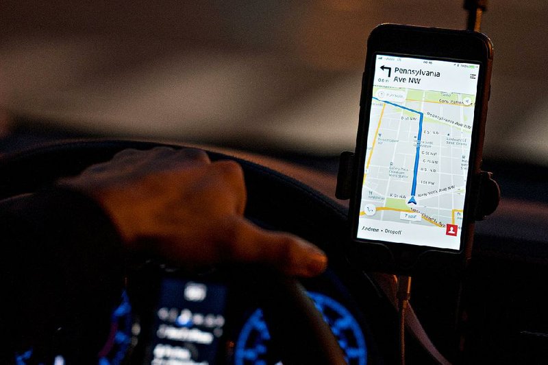 A driver uses an Uber Technologies Inc. car-service app in Washington, D.C., in November. 