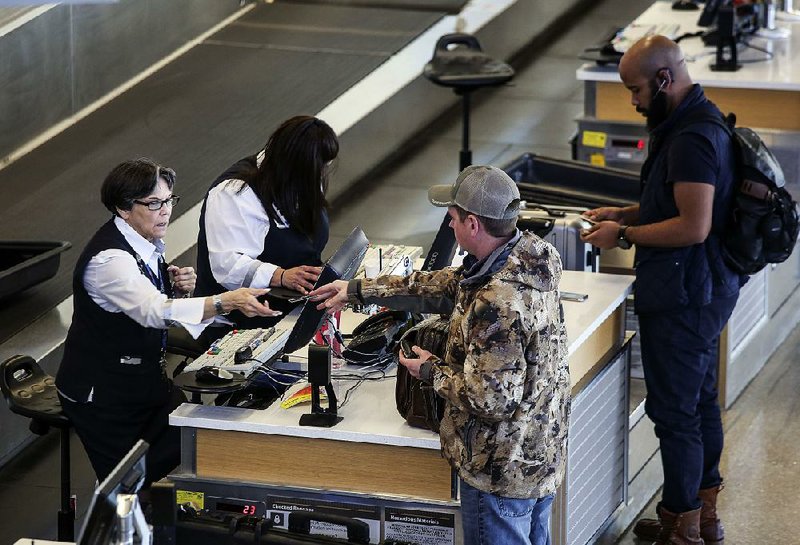 Travelers check in for a flight at Bill and Hillary Clinton National Airport/Adams field on Wednesday. The average price of a flight from Little Rock in 2017 was $445.35. 