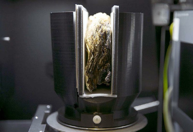 The leaves of a severely scorched manuscript, or codex, which was written in Coptic sometime between A.D. 400 and 600 in Egypt, is scanned by X-ray at the Morgan Library and Museum in New York in December. Pioneers of new software for reading damaged parchment and scrolls are now deploying a CT scanner at the library, hoping to recover the biblical text. 