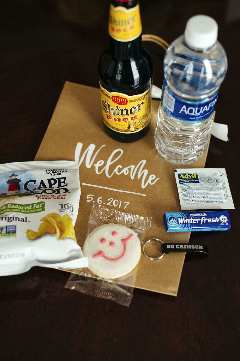 When couples choose “welcome gifts” or wedding favors, many are focusing on items that relate directly to their history and interests, as seen in this “welcome bag” containing a keychain from a couple’s college, a cookie from a restaurant chain the bride remembered from her childhood and a bottle of the groom’s favorite beer, among other items.