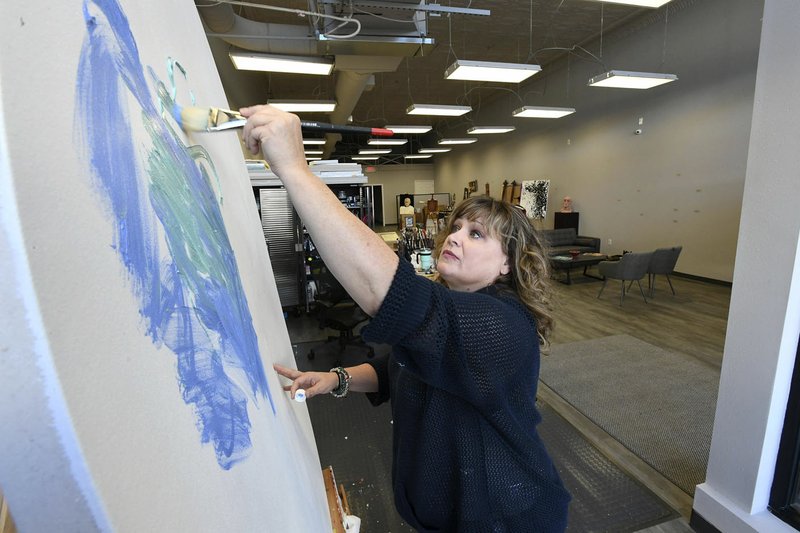 NWA Democrat-Gazette/J.T. WAMPLER Artist Shawna Elliott paints Thursday at 1 Seventeen Create in Springdale. The space features artists’ work space as well as gallery and exhibition space. The Walton Family Foundation has partnered with national nonprofit group Artspace on a $400,000 grant to develop space for artists and creatives to live, work, exhibit and perform. Artspace will lead public meetings centered around arts-driven economic development and conduct a feasibility and market study for Fayetteville, Springdale, Rogers and Bentonville, as well as tour prospective sites for development.