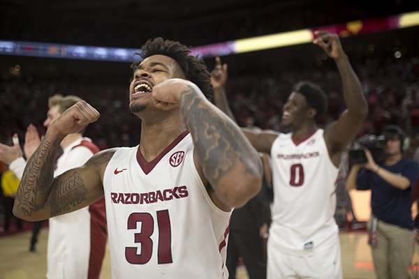 Arkansas guards Anton Beard (31) and Jaylen Barford (0) celebrate following the Razorbacks' 66-65 win over Oklahoma State on Saturday, Jan. 27, 2018, in Fayetteville. 