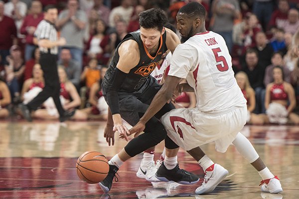 Arkansas forward Arlando Cook (5) defends Oklahoma State guard Lindy Waters III during a game Saturday, Jan. 27, 2018, in Fayetteville. 