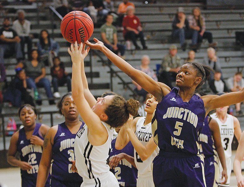 Terrance Armstard/News-Times Smackover’s Precious Dorman (4) and Junction City’s Taykeetria Rogers (5) compete for the ball during their game at Smackover on Friday. Junction City topped Smackover 48-47.