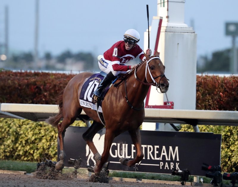 Jockey Florent Geroux celebrates as Gun Runner crosses the finish line to win the Pegasus World Cup Invitational horse race, Saturday, Jan. 27, 2018, at Gulfstream Park in Hallandale Beach, Fla. (AP Photo/Lynne Sladky)