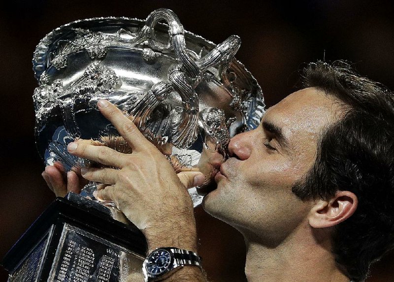 Switzerland’s Roger Federer kisses the championship trophy after defeating Croatia’s Marin Cilic 6-2, 6-7 (5), 6-3, 3-6, 6-1 in the men’s singles final at the Australian Open on Sunday in Melbourne. It was the sixth Australian Open title for Federer and his 20th Grand Slam title overall.