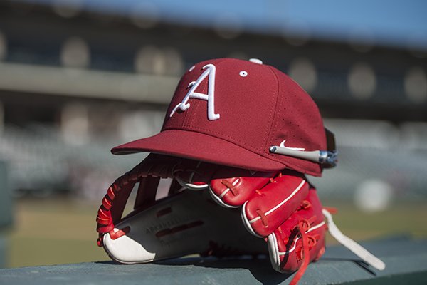 An Arkansas hat and glove sit at Baum Stadium during practice Saturday, Jan. 27, 2018, in Fayetteville. 