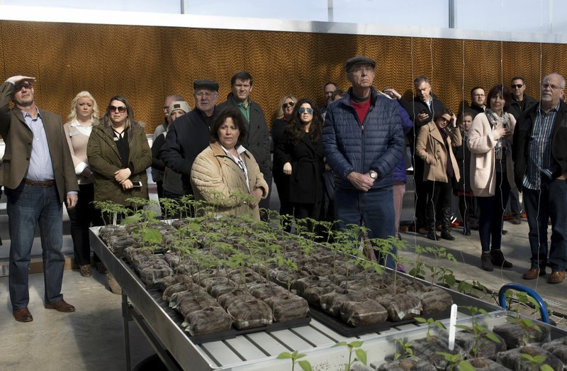 Attendees admire the new greenhouse Monday at Brightwater.
