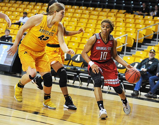 Submitted photo STATE AND STATE: Arkansas State redshirt junior Akasha Westbrook (10) drives against Appalachian State's Bayley Plummer (42) in Boone, N.C., Saturday. The Red Wolves were 1-1 in a road trip this week.